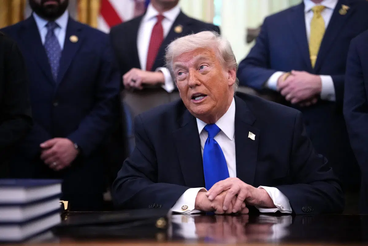 Trump defends Iran deal as implementation talks begin